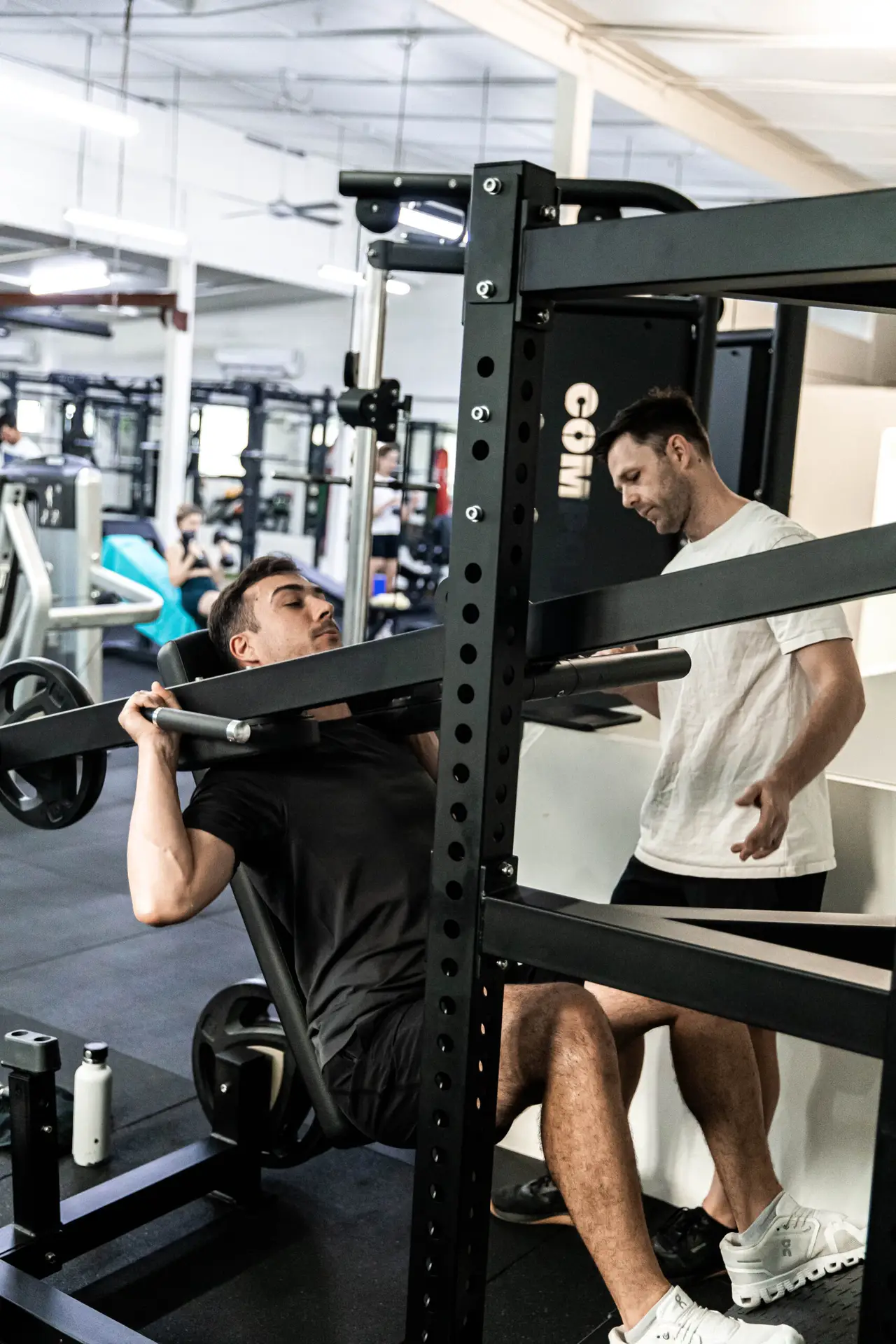 A coach guiding a member through a lift at Catalyst Training Co Randwick